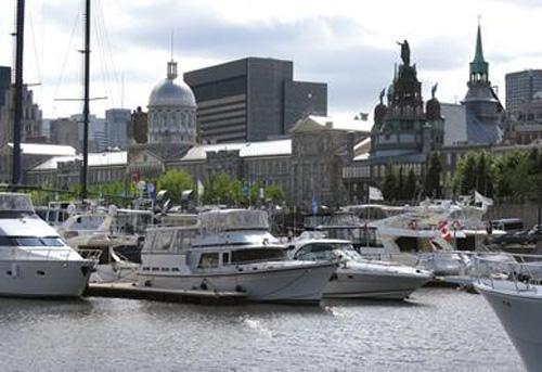 Yacht CLub Montreal on the eastern end of the Old Port - Overlooking the harbour is 'The Sailor's Church', Notre Dame Chapel with 'Our lady of the Harbour statue atop it's dome. © The Galley Guys